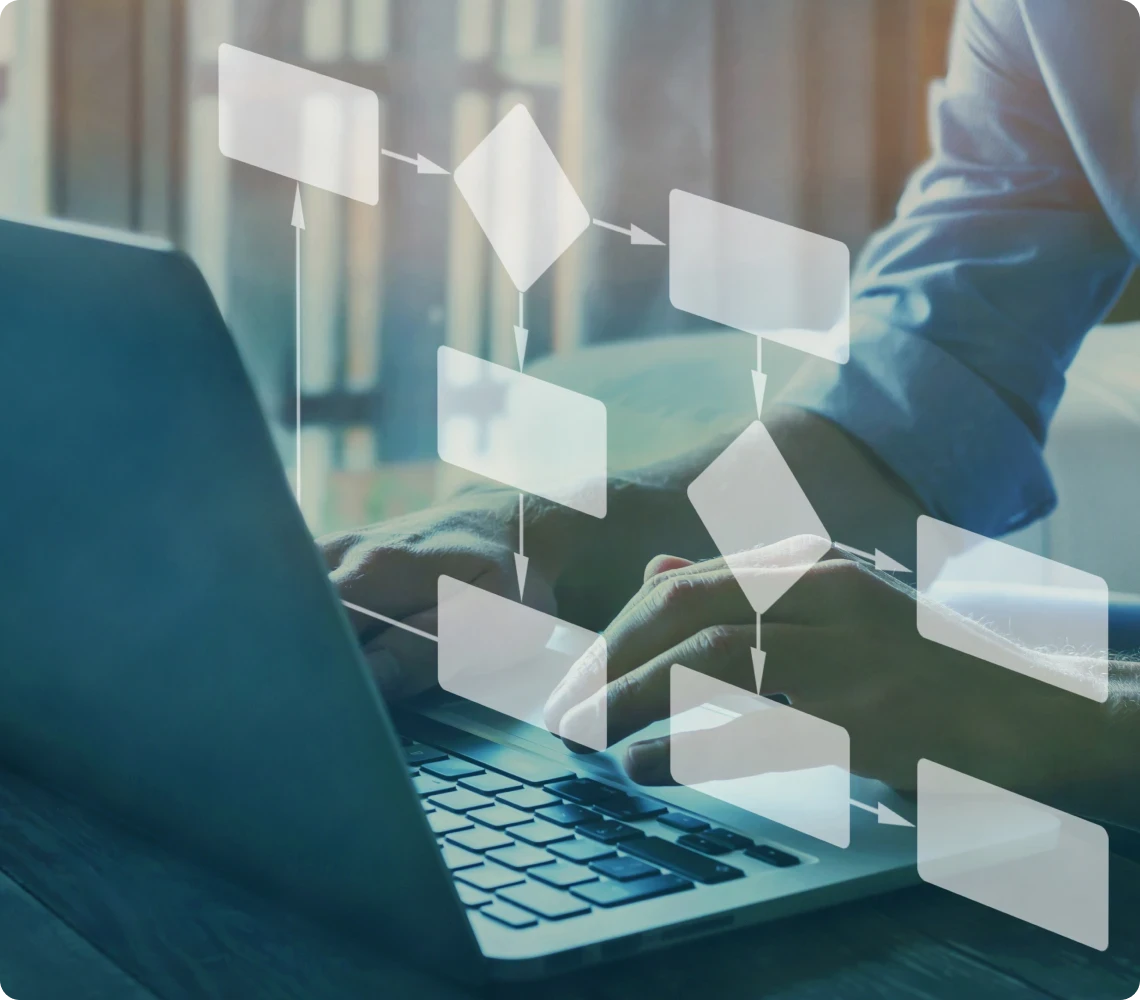 Person using a laptop with an overlay of a flowchart diagram on the screen, indicating a process or workflow.