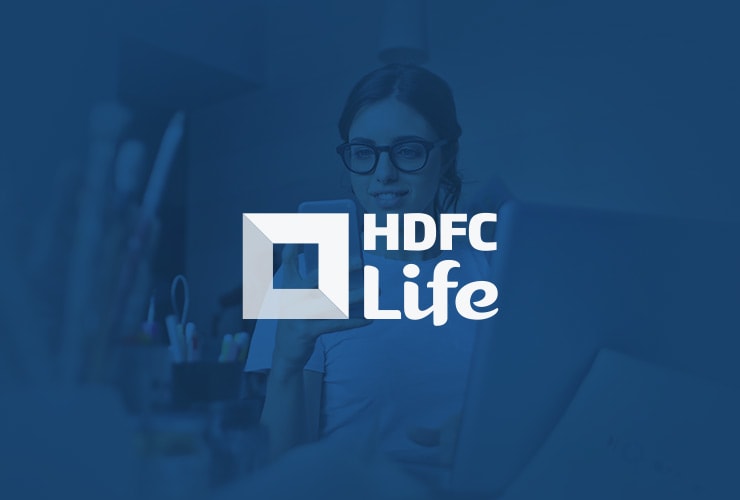 A person wearing glasses looks at their phone while sitting at a desk, with the HDFC Life logo prominently displayed in front.