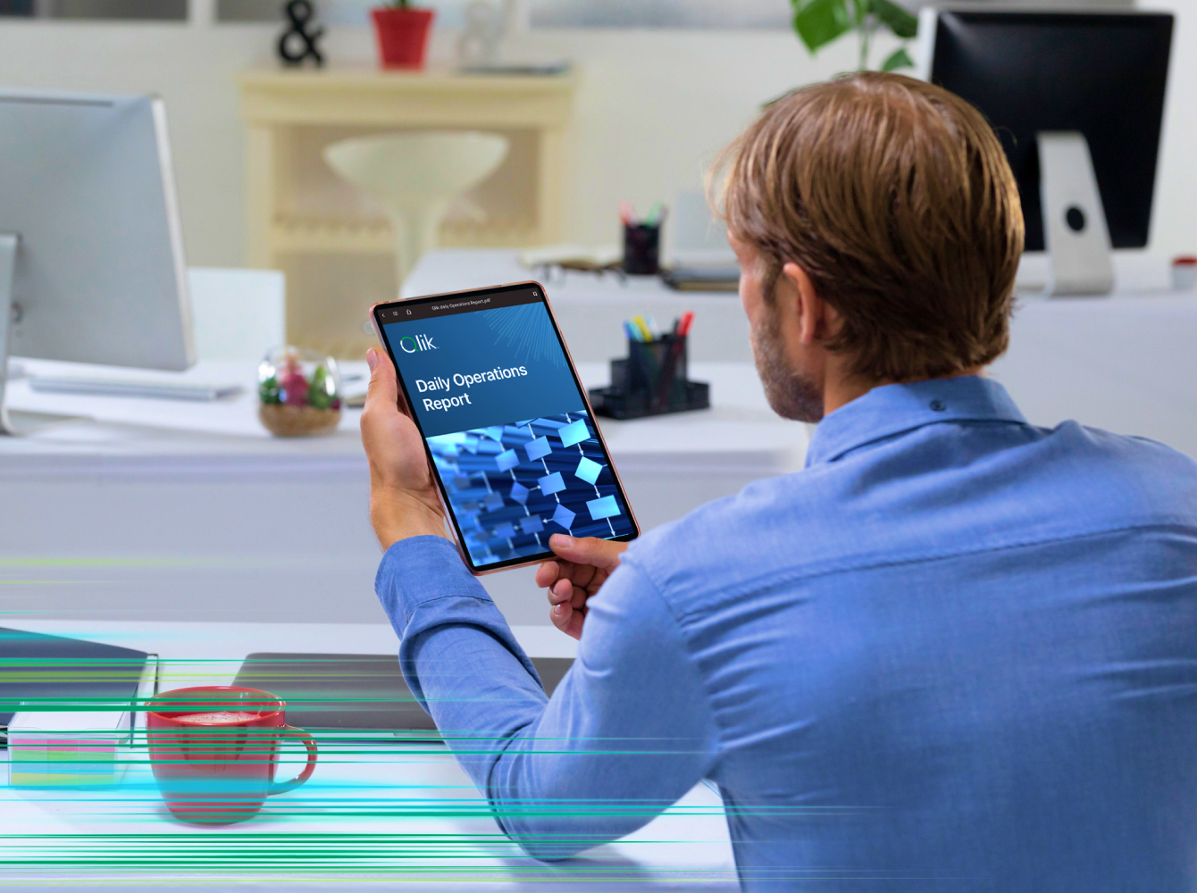 A man at his desk uses a tablet to analyze daily operations report, symbolizing a shift from outdated systems to efficient inventory management.