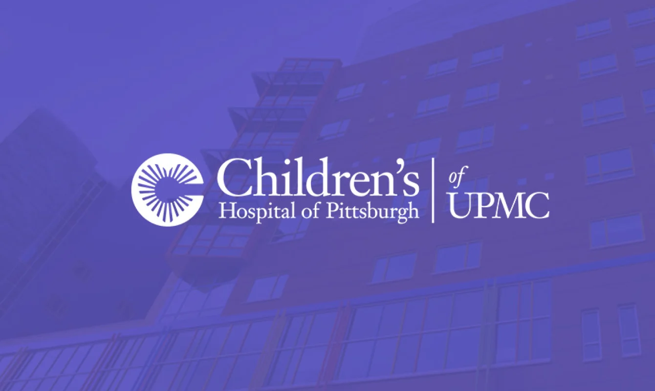 Logo of Children's Hospital of Pittsburgh of UPMC overlaid on a background image of a multi-story hospital building.